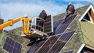 Workers,Installing,Solar,Panels,On,Private,Home,Hexagonal,Roof,Felt