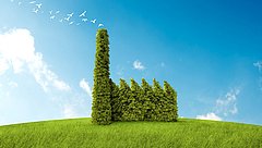 Ein grüner Hügel mit einer Fabrik aus Pflanzen.