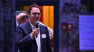 Ein Mann hält eine Rede auf der Bühne